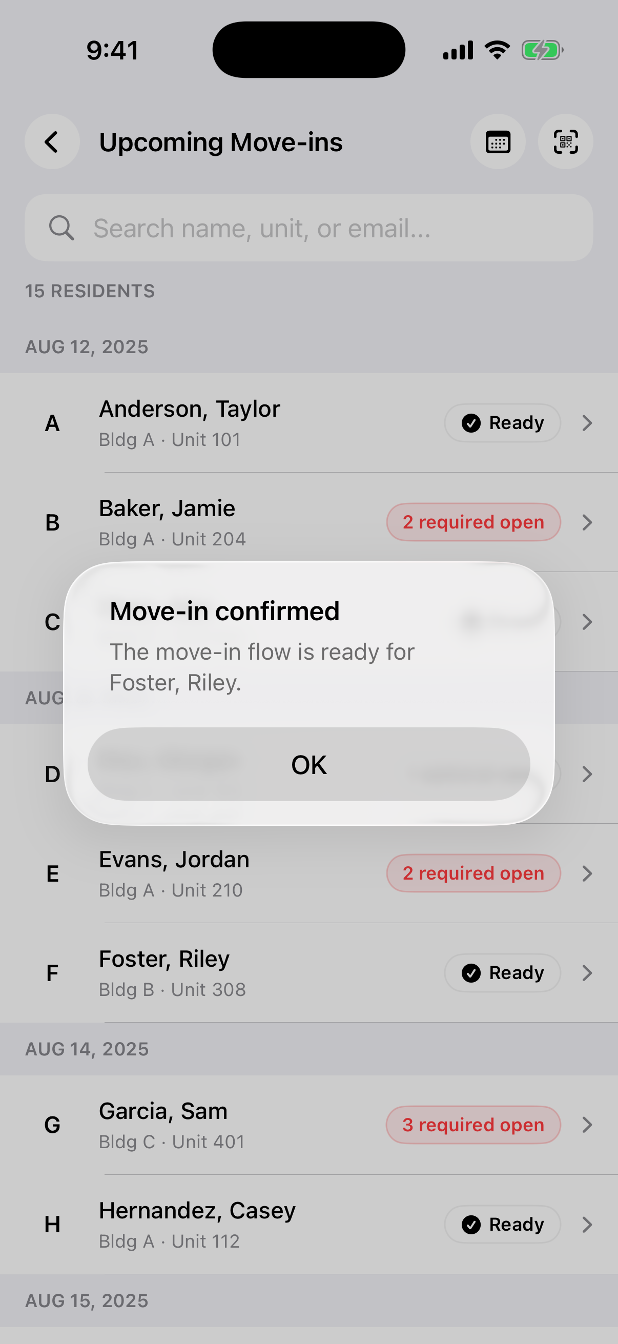 Roster dimmed behind a Move-in confirmed system alert with an OK button.